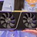 Detailed shot of hands holding a modern graphics card indoors.