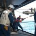 US Navy 050602-N-4702D-052 Boatswain's Mate 2nd Class Arvin Illaccabrera helps guide the Royal Australian Navy warship HMAS Success (AOR 304) fuel probe into a refueling station.jpg