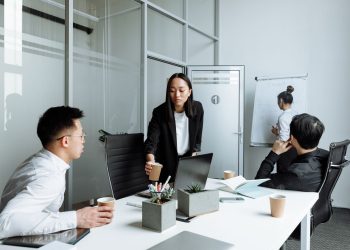 Diverse office team engaged in a collaborative meeting discussing business strategies.