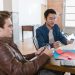 Two young entrepreneurs brainstorm ideas in a modern office setting, fostering innovation and collaboration.