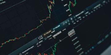Close-up of stock market trading screen displaying financial growth and charts.