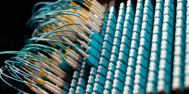 From below of long thin identical blue cables connected to small round electrical connectors