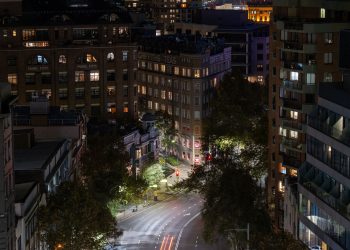 Captured Griffiths Teas Building and city lights illuminating a quiet night in downtown Sydney, Australia.