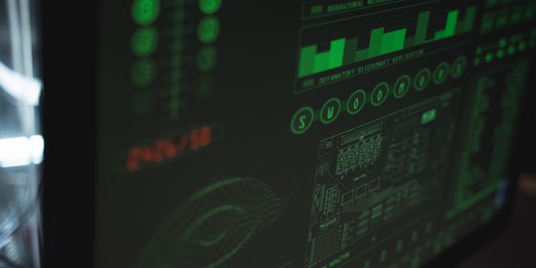 Close-up view of a computer displaying cybersecurity and data protection interfaces in green tones.