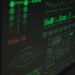 Close-up view of a computer displaying cybersecurity and data protection interfaces in green tones.