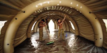 Australian Medical Task Force personnel conduct an initial clean of the inflatable medical Health Facility in Camp Cockatoo. Pakistan 2010. Photo Australian Defence (10674660385).jpg