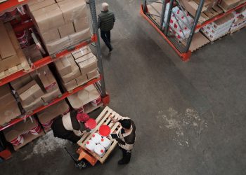 High angle view of warehouse workers handling inventory and logistics operations.