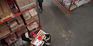 High angle view of warehouse workers handling inventory and logistics operations.