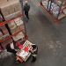 High angle view of warehouse workers handling inventory and logistics operations.