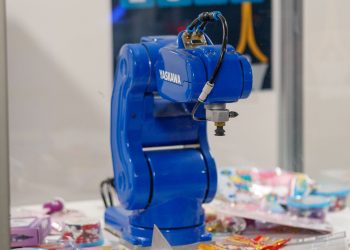 A blue Yaskawa industrial robot arm on display, showcasing advanced technology and robotics.