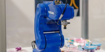 A blue Yaskawa industrial robot arm on display, showcasing advanced technology and robotics.