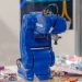 A blue Yaskawa industrial robot arm on display, showcasing advanced technology and robotics.