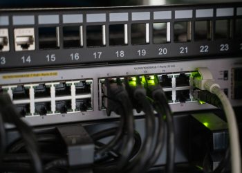 Networking equipment with connected cables, showcasing modern technology infrastructure.
