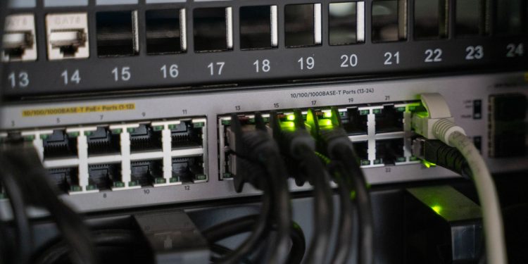 Networking equipment with connected cables, showcasing modern technology infrastructure.