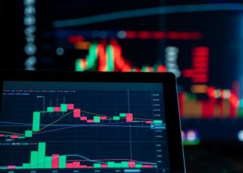 Close-up view of digital trading chart screen with vibrant graphs and data analysis.
