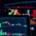 Close-up view of digital trading chart screen with vibrant graphs and data analysis.