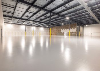 Empty modern warehouse interior with polished floor and ample space located in Texas.