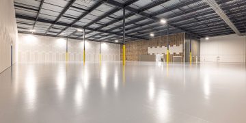 Empty modern warehouse interior with polished floor and ample space located in Texas.