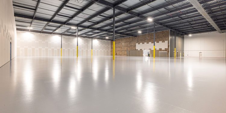 Empty modern warehouse interior with polished floor and ample space located in Texas.