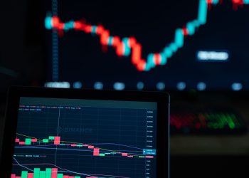 Detailed view of cryptocurrency trading charts on digital screens, showcasing market fluctuations.