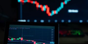 Detailed view of cryptocurrency trading charts on digital screens, showcasing market fluctuations.
