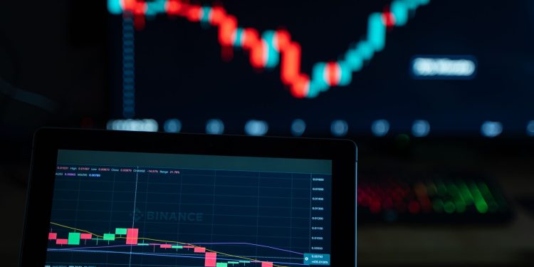 Detailed view of cryptocurrency trading charts on digital screens, showcasing market fluctuations.