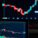 Detailed view of cryptocurrency trading charts on digital screens, showcasing market fluctuations.