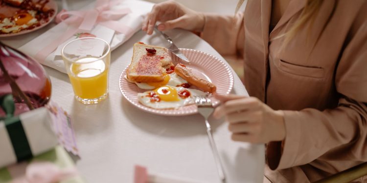 A person enjoys a breakfast of egg, toast, and orange juice. Perfect start to the day.