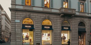 A stylish view of a Prada store facade in Florence, Italy, during evening hours.